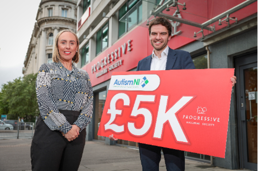 A person and person standing in front of a building holding a sign
AI-generated content may be incorrect.